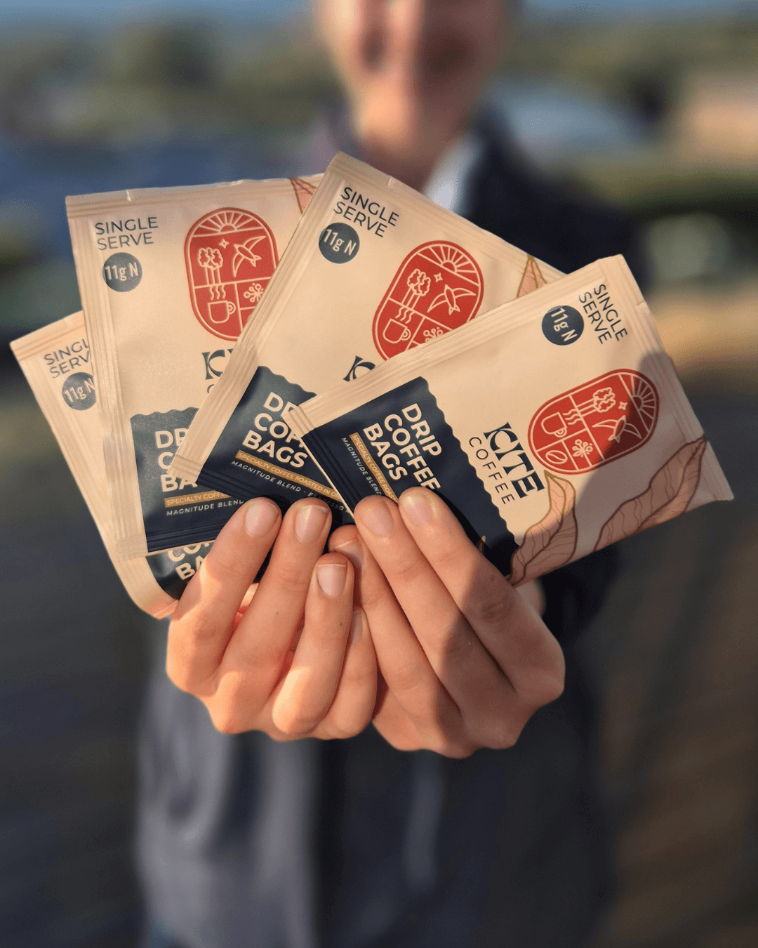 Person holding coffee drip bags wrapped in foil